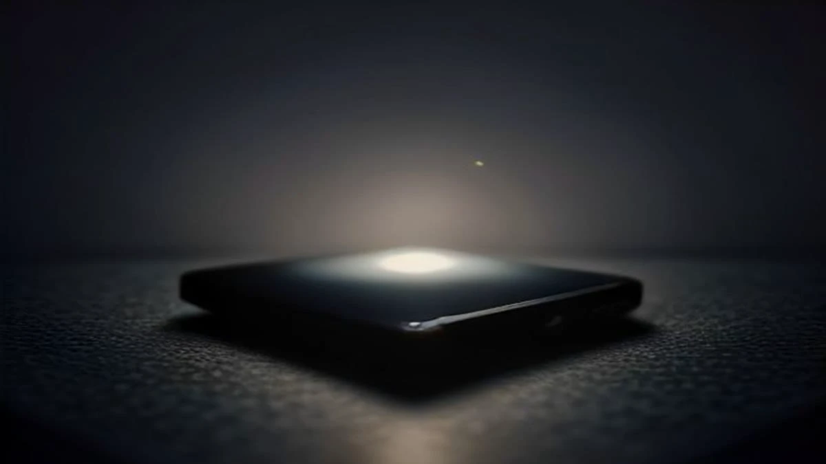 A smartphone on a dark desk with a softly glowing abstract chat interface, shallow depth of field